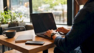 Hands poised over laptop in ecommerce workspace
