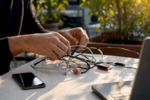 Hand checking network cables on desk