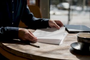 Hands reviewing strategic acquisition documents