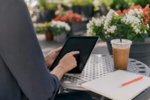 Hands interacting with a tablet for chatbot