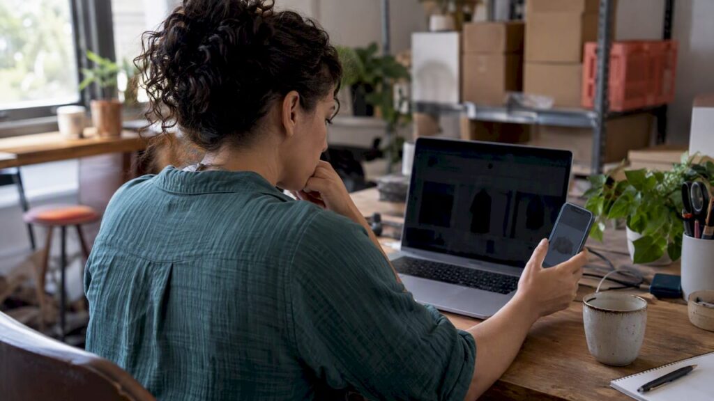 Founder comparing ecommerce storefront previews on devices